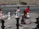 Kids moving giant chess pieces